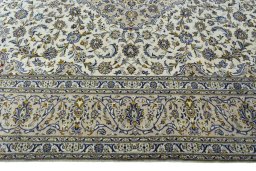 Corner detail of 2000s Kashan rug showing border pattern and Wool pile