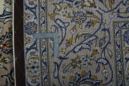 Backside of handmade 2000s Kashan rug showing knot structure and weave density
