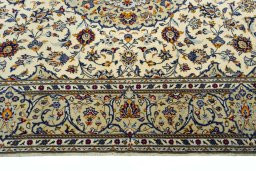 Corner detail of 2000s Kashan rug showing border pattern and Cork pile