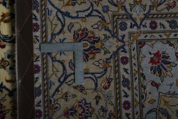Backside of handmade 2000s Kashan rug showing knot structure and weave density