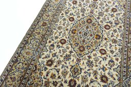 Backside of handmade 2000s Kashan rug showing knot structure and weave density