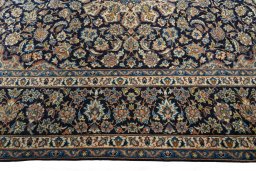 Corner detail of 2000s Kashan rug showing border pattern and Wool pile