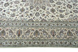 Corner detail of 2000s Kashan rug showing border pattern and Wool pile