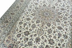 Backside of handmade 2000s Kashan rug showing knot structure and weave density