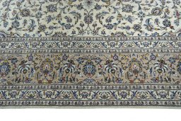 Corner detail of 2000s Kashan rug showing border pattern and Wool pile