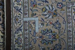 Backside of handmade 2000s Kashan rug showing knot structure and weave density