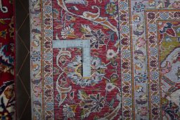 Backside of handmade New Kashan rug showing knot structure and weave density