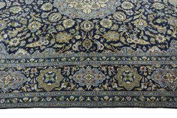 Corner detail of 2000s Kashan rug showing border pattern and Wool pile