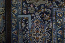 Backside of handmade 2000s Kashan rug showing knot structure and weave density