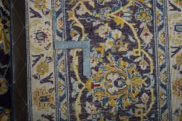 Backside of handmade 2000s Kashan rug showing knot structure and weave density