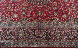 Corner detail of 2000s Kashan rug showing border pattern and Wool pile