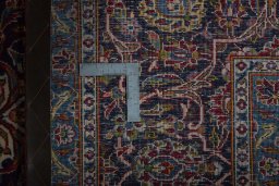 Backside of handmade 2000s Kashan rug showing knot structure and weave density