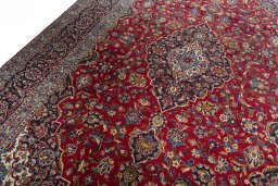 Backside of handmade 2000s Kashan rug showing knot structure and weave density