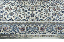 Corner detail of 2000s Kashan rug showing border pattern and Wool pile