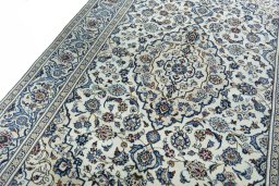 Backside of handmade 2000s Kashan rug showing knot structure and weave density