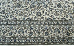 Corner detail of 2000s Kashan rug showing border pattern and Wool pile