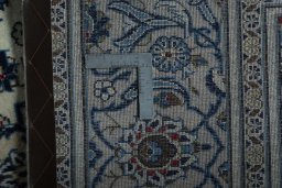 Backside of handmade 2000s Kashan rug showing knot structure and weave density