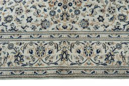 Corner detail of 2000s Kashan rug showing border pattern and Wool pile