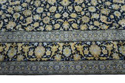 Corner detail of 2000s Kashan rug showing border pattern and Wool pile