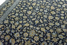 Backside of handmade 2000s Kashan rug showing knot structure and weave density