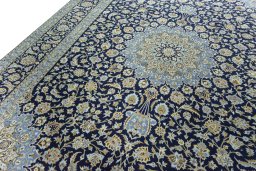 Backside of handmade 2000s Kashan rug showing knot structure and weave density