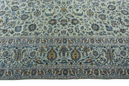Corner detail of 2000s Kashan rug showing border pattern and Wool pile