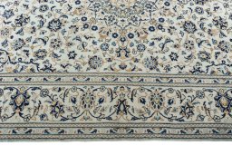 Corner detail of 2000s Kashan rug showing border pattern and Wool pile