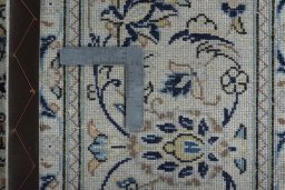 Backside of handmade 2000s Kashan rug showing knot structure and weave density