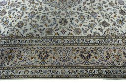Corner detail of 2000s Kashan rug showing border pattern and Wool pile