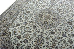 Backside of handmade 2000s Kashan rug showing knot structure and weave density