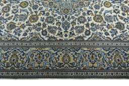 Corner detail of 2000s Kashan rug showing border pattern and Wool pile