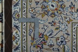Backside of handmade 2000s Kashan rug showing knot structure and weave density