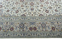 Corner detail of 2000s Kashan rug showing border pattern and Wool pile