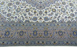 Corner detail of 2000s Kashan rug showing border pattern and Wool pile