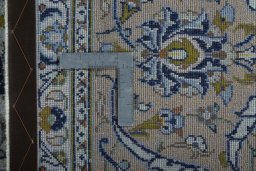 Backside of handmade 2000s Kashan rug showing knot structure and weave density