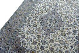 Backside of handmade 2000s Kashan rug showing knot structure and weave density