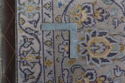 Backside of handmade 2000s Kashan rug showing knot structure and weave density