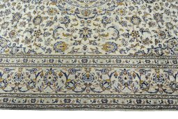 Corner detail of 2000s Kashan rug showing border pattern and Wool pile