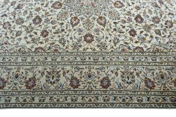 Corner detail of 2000s Kashan rug showing border pattern and Wool pile