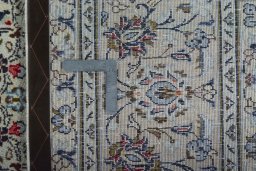 Backside of handmade 2000s Kashan rug showing knot structure and weave density