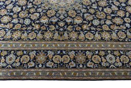 Corner detail of 2000s Kashan rug showing border pattern and Wool pile