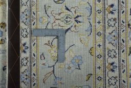 Backside of handmade 2000s Kashan rug showing knot structure and weave density