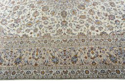 Corner detail of 2000s Kashan rug showing border pattern and Wool pile