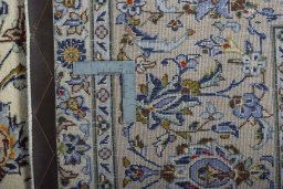 Backside of handmade 2000s Kashan rug showing knot structure and weave density