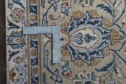 Backside of handmade 2000s Kashan rug showing knot structure and weave density