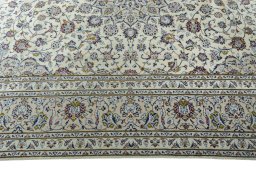 Corner detail of 2000s Kashan rug showing border pattern and Wool pile
