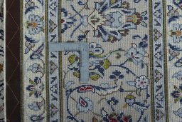 Backside of handmade 2000s Kashan rug showing knot structure and weave density