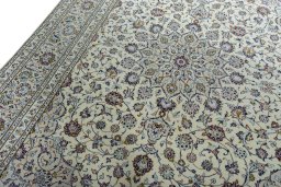 Backside of handmade 2000s Kashan rug showing knot structure and weave density