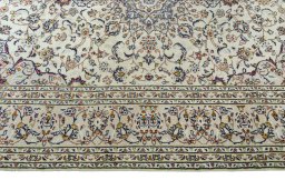 Corner detail of 2000s Kashan rug showing border pattern and Wool pile