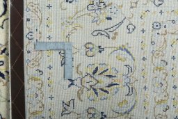 Backside of handmade New Kashan rug showing knot structure and weave density